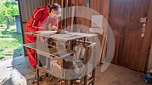 A craftsman examines a part in a workshop