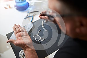 Craftsman examining a set of jewelry details