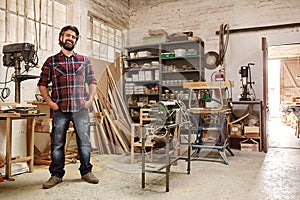 Craftsman in his workshop with heavy-duty woodwork machinery
