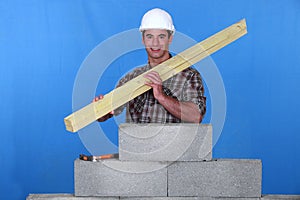 Craftsman holding wooden boards