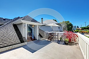 Craftsman house roof top terrace with living area.