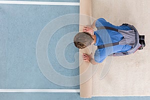 Craftsman In Overalls Unrolling Carpet photo