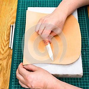 Craftsman polishes leather using flat burnisher photo