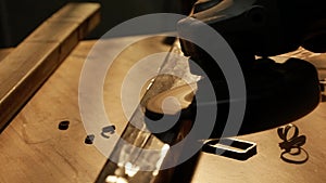 Craftsman in protective gloves working with grinder at industrial plant, man grinding iron detail, sparks flying at the
