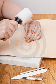 Craftsman puts picture on leather