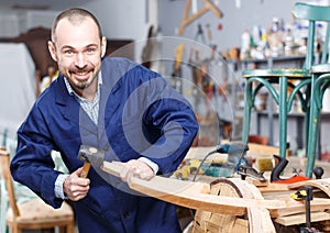 Craftsman repairing antique furniture