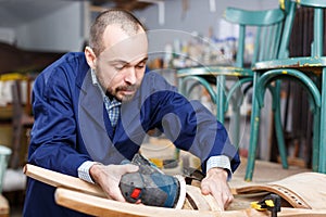 Craftsman repairing antique furniture