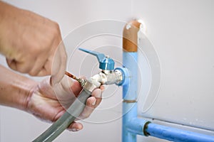 Craftsman repairing a leaky faucet on the kitchen sink