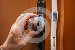 craftsman uninstalling a panel or door mounting, maybe key escutcheon photo