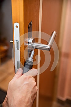 craftsman uninstalling a panel or door mounting, maybe key escutcheon photo
