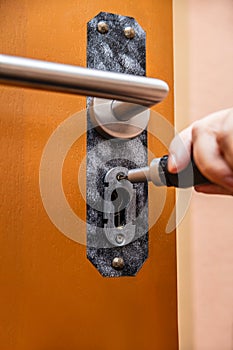 craftsman uninstalling a panel or door mounting, maybe key escutcheon photo