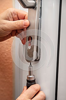 craftsman uninstalling a panel or door mounting, maybe key escutcheon photo