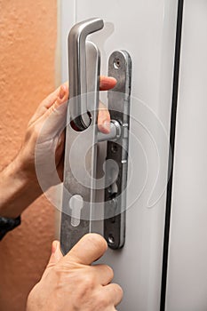 craftsman uninstalling a panel or door mounting, maybe key escutcheon photo