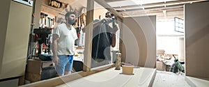 Craftsman using electric sander, to smoothen the wood texture photo