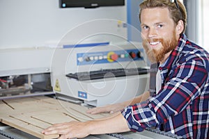 craftsman using wood cutting machine