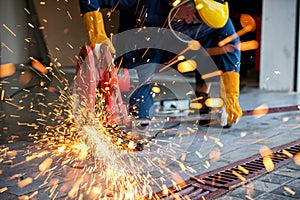 Craftsman Welding is Cutting Steel Work, Welder Man in Safety Protective Equipment Doing Metalwork in Construction Site.