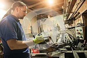 Craftsman worker working on steel structure in factory