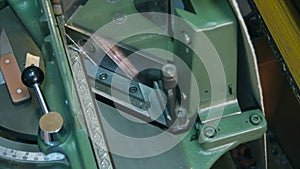 Craftsman working on frame in frame shop, using machine