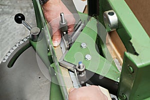 Craftsman working on frame in frameshop.