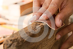 Craftsman working use sandpaper sanding plank wood