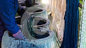 Craftsmen of Thai indigo cotton. Indigo on hand. The jar Indigo is used for dyeing cotton in natural colors Is the wisdom of