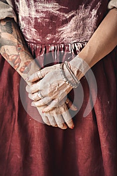 Craftsperson Concept. Young woman artist standing  on dark hands in dust close-up