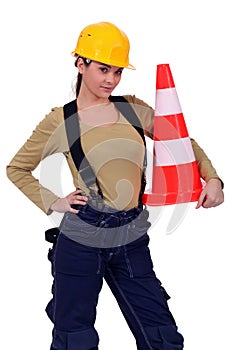 Craftswoman holding traffic cone