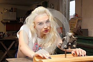 Craftswoman at power saw