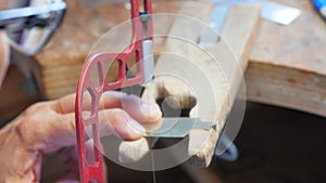 Craftswoman using hacksaw