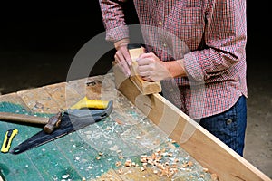 Craftswoman working with wooden plane. DIY, woodwork concept