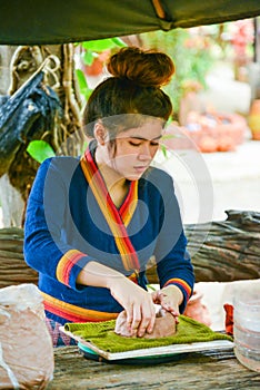 Craftwoman making pottery of dolls and sculpture of animals