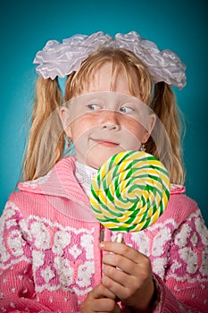 Crafty girl with big lollipop photo