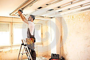 Crafty worker arranging ceiling construction