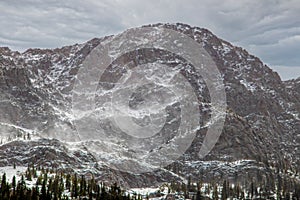 Craggy Colorado Mountains near Durango after late snowfall with snow blowing from peaks