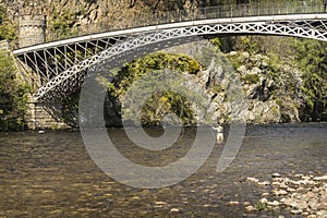 Craigellachie Bridge over the River Spey in Scotland.