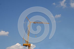 Crain construction building in blue sky.