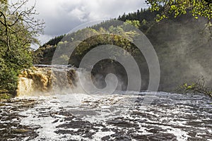 Crammel Linn waterfall on the Norhumberland Cumbria border, UK in full flow photo