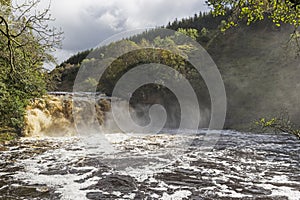 Crammel Linn waterfall on the Norhumberland Cumbria border, UK in full flow photo
