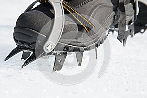 Crampons bite into hard snow. Climbing equipment.