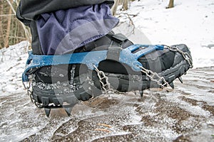 Crampons on black hiking boots