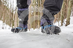 Crampons on black hiking boots photo