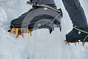 Crampons close-up on his feet ice climber, climber on a frozen w