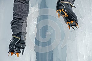 Crampons close-up on his feet ice climber, climber on a frozen w