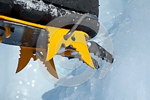 Crampons close-up on his feet ice climber, climber on a frozen waterfall