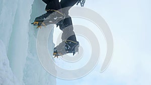 Crampons close-up on his feet ice climber, climber on a frozen waterfall