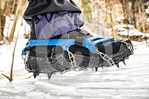 Crampons on hiking boot. Hiking in winter