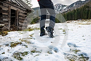 Crampons on shoes. Mountain trails in winter.