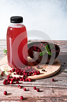 Cranberries and cranberry juice in a plastic bottle