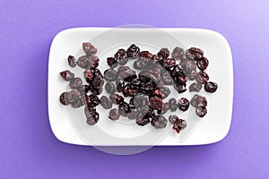 Cranberries on rectangular white plate with rounded corners.