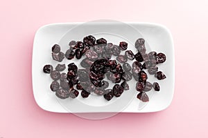 Cranberries on rectangular white plate with rounded corners.